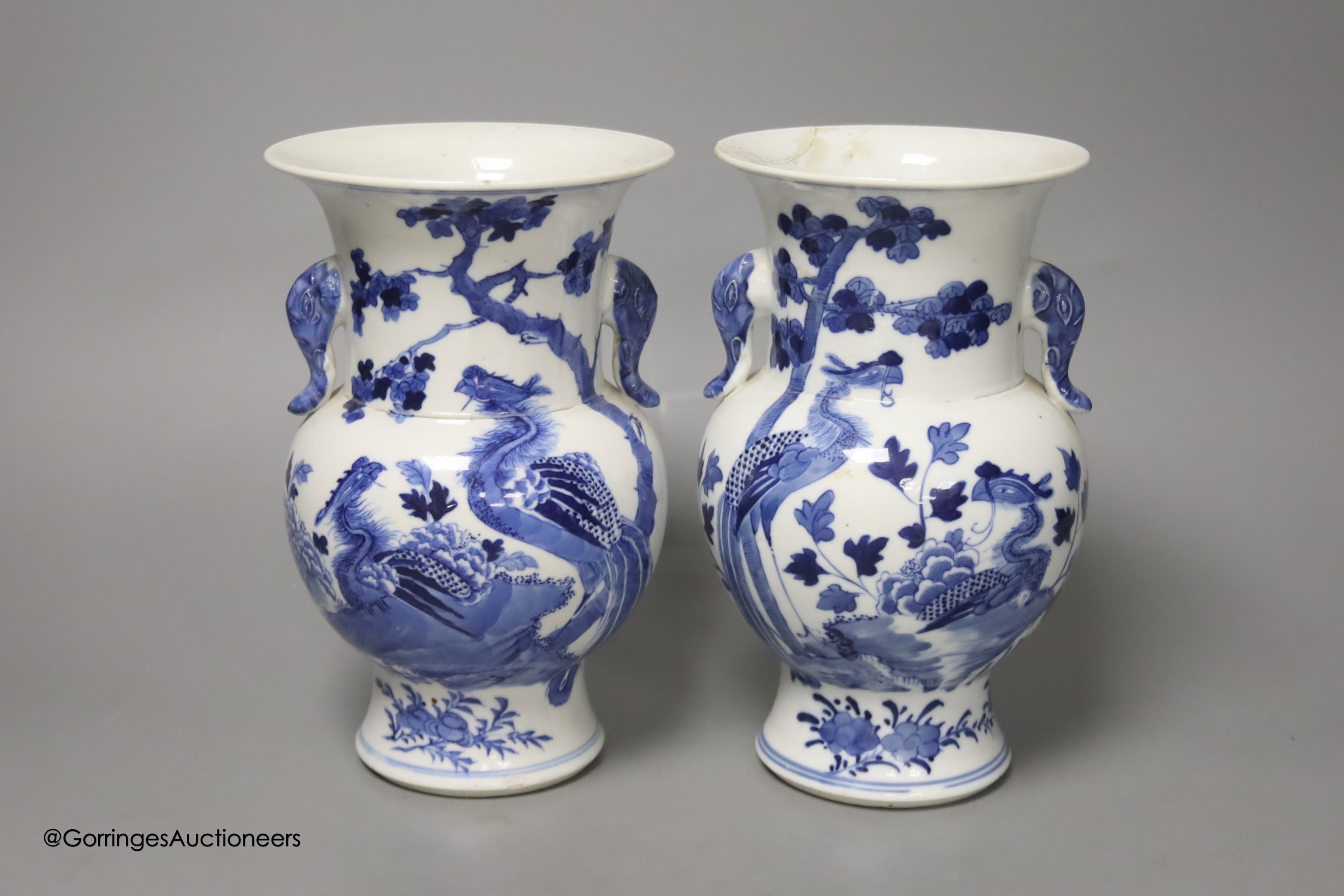A pair of Chinese blue and white 'phoenix' vases, Kangxi marks but late 19th century, height 20cm (a.f.)